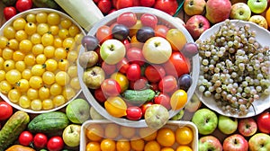 ÃÂ Many ripe delicious and juicy different colors of vegetables and fruits lie in and around the plates on a wooden table!